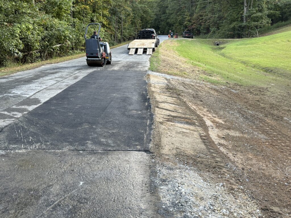 a tractor on a road after completing an asphalt patch for Paulding County, GA.