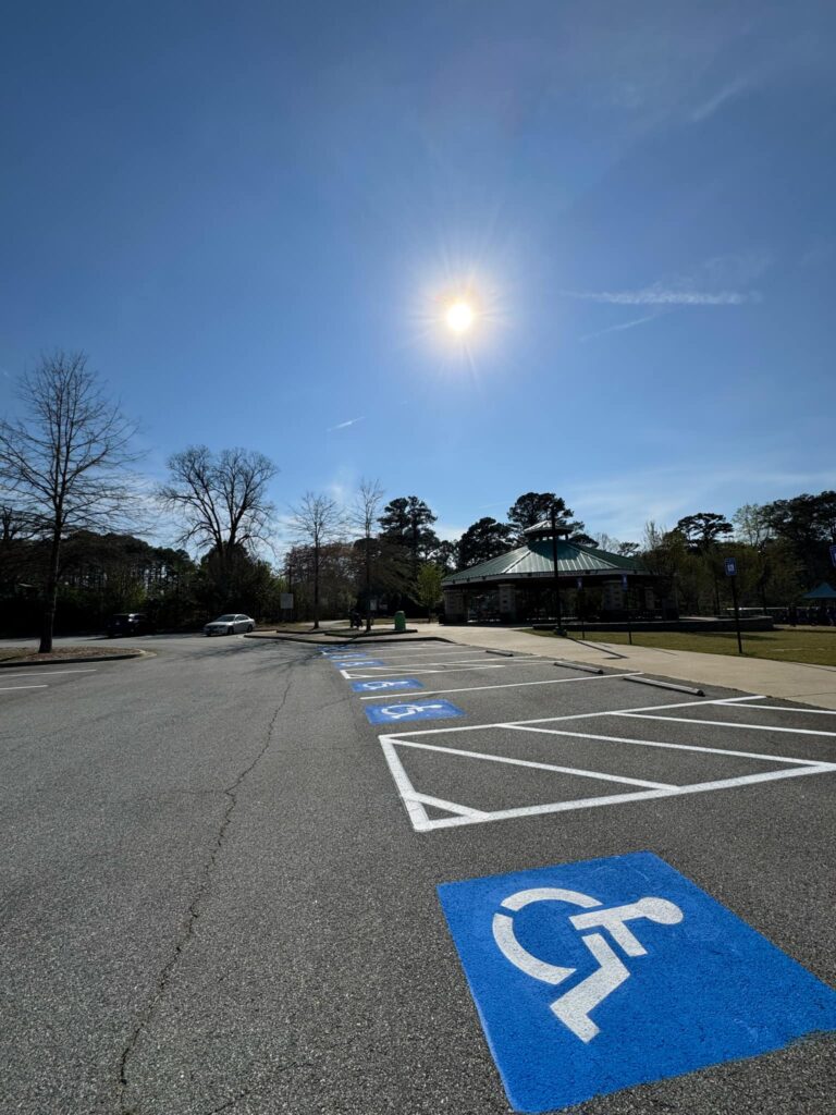 a parking lot with a parking lot and a parking lot with a parking lot and trees and a building and a parking lot with a parking lot and a parking lot with a parking lot and a parking